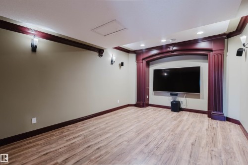 Spacious room featuring wood-finish flooring and recessed ceiling lights - 2408 Tegler Green, Edmonton, AB - Indoor Photo Showing Other Room