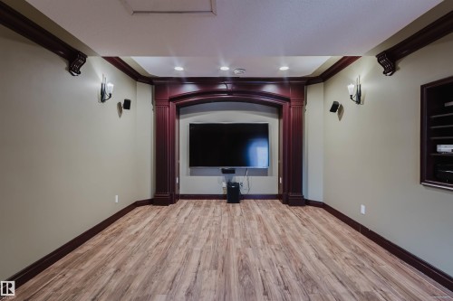 Entertainment room featuring wood-finish flooring, recessed lighting, and built-in wall sconces - 2408 Tegler Green, Edmonton, AB - Indoor Photo Showing Other Room