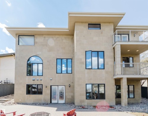 Stone block exterior with multiple window styles, including an arched window and awning windows - 2408 Tegler Green, Edmonton, AB - Outdoor With Balcony With Exterior