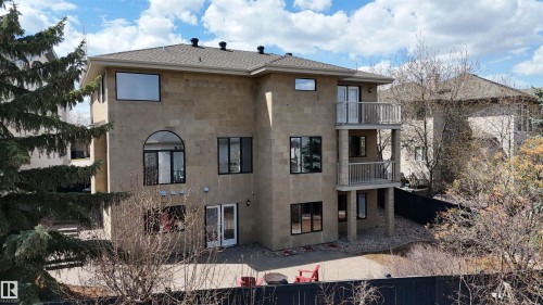 Stone exterior home featuring a multi-level design with numerous windows - 2408 Tegler Green, Edmonton, AB - Outdoor