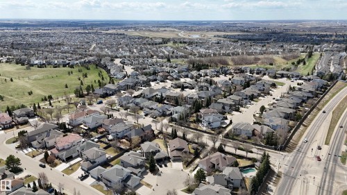 Residential neighborhood with a mix of single-family homes, green spaces, and a multi-lane roadway - 2408 Tegler Green, Edmonton, AB - Outdoor With View