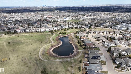 Aerial perspective featuring a residential area with a prominent pond and surrounding green space - 2408 Tegler Green, Edmonton, AB - Outdoor With View