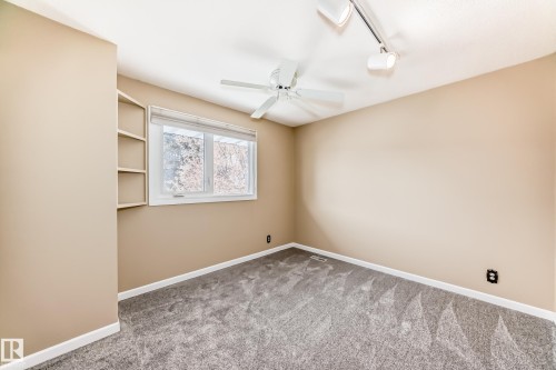 Upper bedroom with a built in corner shelf, Closet has built in shelving. New carpet. Window faces the side yard. - 38 Lancaster Crescent, St. Albert, AB - Indoor Photo Showing Other Room