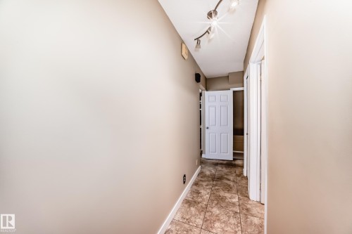 Hallway from the back door entry towards the lower level. - 38 Lancaster Crescent, St. Albert, AB - Indoor Photo Showing Other Room
