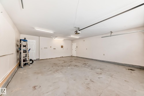 Drywalled, insulated R60 +, painted, 2 exit doors one to the rear and one to the front entry. Hot and cold water, intercom/radio, vacuum outlet. Floor painted. - 38 Lancaster Crescent, St. Albert, AB - Indoor Photo Showing Garage