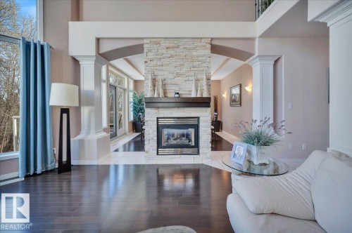 DUAL SIDED GAS FIREPLACE, SHARED WITH THE FORMAL DINING SPACE - 314 Weaver Point(E), Edmonton, AB - Indoor Photo Showing Living Room With Fireplace