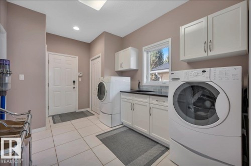 WITH PEDESTAL WASHER AND DRYER, SINK AND UPPER CABINETS - 314 Weaver Point(E), Edmonton, AB - Indoor Photo Showing Laundry Room