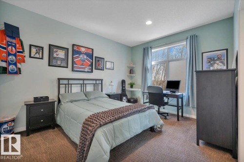 2ND OF 2 MAIN FLOOR BEDROOMS WITH CUSTOM CLOSET ORGANIZERS - 314 Weaver Point(E), Edmonton, AB - Indoor Photo Showing Bedroom