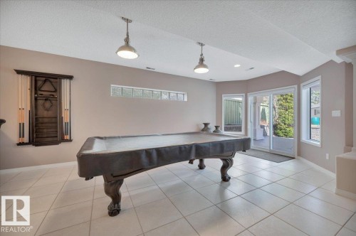 GAMES ROOM COMPLETE WITH POOL TABLE AND ACCESSORIES WITH DOOR LEADING TO THE LOWER LEVEL PATIO AND BACK YARD - 314 Weaver Point(E), Edmonton, AB - Indoor Photo Showing Other Room