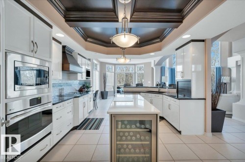 BEAUTIFUL COFFERED CEILING, GE PROFILE WALL OVEN AND MICROWAVE,  CENTRAL ISLAND WITH GE PROFILE BEVERAGE CENTRE - 314 Weaver Point(E), Edmonton, AB - Indoor Photo Showing Kitchen With Upgraded Kitchen
