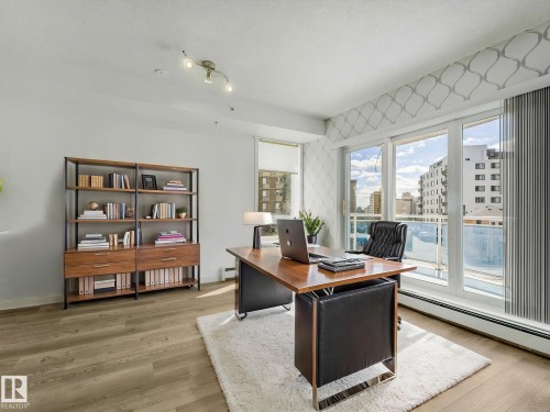 Bright room featuring wood-finish flooring and a built-in bookshelf - 305 10504 99 Avenue, Edmonton, AB - Indoor Photo Showing Office