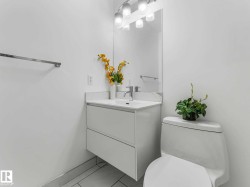 Bathroom featuring a wall-mounted vanity with integrated sink, chrome faucet, and mirrored medicine cabinet - 