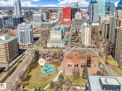Urban landscape featuring a prominent red brick building, surrounding parkland with a gazebo, and a diverse collection of high-rise structures - 305 10504 99 Avenue, Edmonton, AB - Outdoor