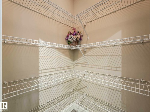 Corner pantry featuring multiple levels of white wire shelving - 305 10504 99 Avenue, Edmonton, AB - Indoor With Storage