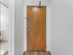 Natural wood-finish entry door with modern hardware - 