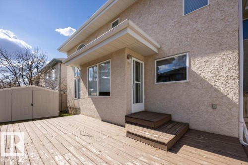 Spacious outdoor deck featuring wooden planks, a two-step entry, and stucco exterior - 11551 14 Avenue, Edmonton, AB - Outdoor With Exterior