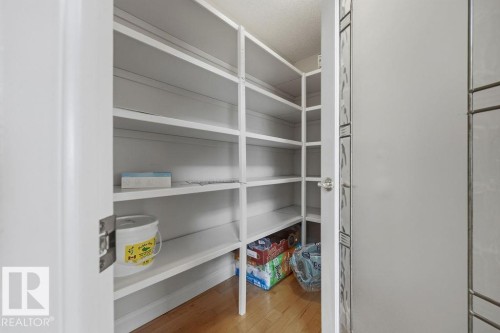 Walk-in pantry featuring extensive white shelving - 11551 14 Avenue, Edmonton, AB - Indoor With Storage