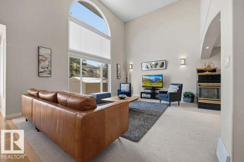 Vaulted ceiling with an arched window and glass slider - 11551 14 Avenue, Edmonton, AB - Indoor