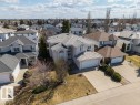 Stucco exterior residence featuring an arched entry, a two-car garage, an additional single-car garage, and a concrete driveway - 11551 14 Avenue, Edmonton, AB  - Outdoor With Facade 