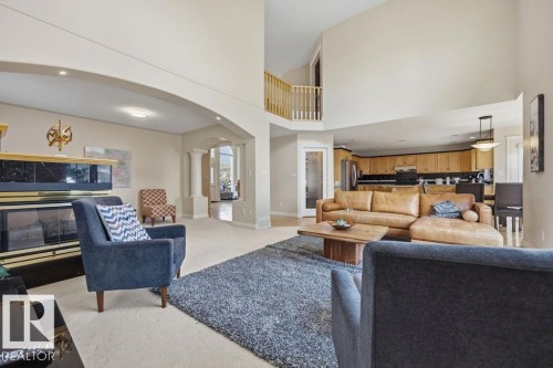 Spacious living area featuring a vaulted ceiling and an upper-level balcony - 11551 14 Avenue, Edmonton, AB - Indoor Photo Showing Living Room
