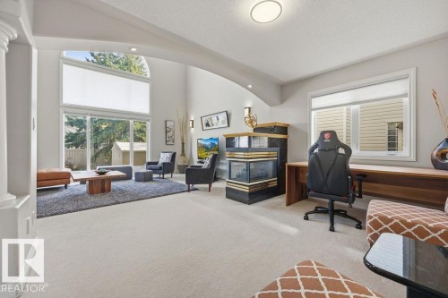 Vaulted ceilings above a floor-to-ceiling glass wall with sliding door access to the exterior - 11551 14 Avenue, Edmonton, AB - Indoor