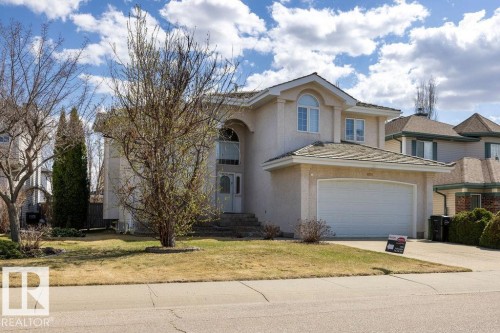 Stucco-finished residence featuring an arched portico entryway, an attached two-car garage, and a gabled roofline - 11551 14 Avenue, Edmonton, AB - Outdoor With Facade