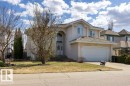 Stucco-finished residence featuring an arched portico entryway, an attached two-car garage, and a gabled roofline - 11551 14 Avenue, Edmonton, AB  - Outdoor With Facade 