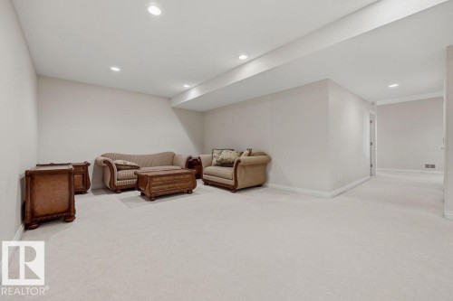 Expansive carpeted room featuring recessed lighting, light-toned walls, and white baseboards - 11551 14 Avenue, Edmonton, AB - Indoor