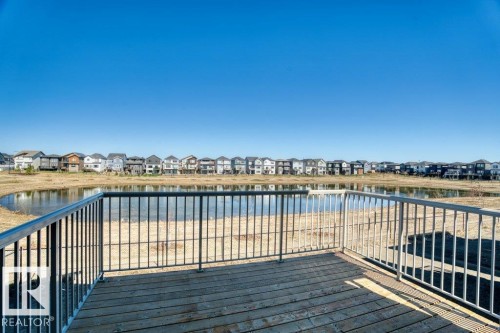Outdoor deck with wood planks and a metal railing - 19110 20A Avenue, Edmonton, AB - Outdoor