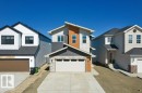 Contemporary facade featuring mixed siding, stone accents, and an integrated garage - 19110 20A Avenue, Edmonton, AB  - Outdoor 