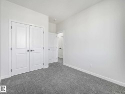 Bedroom featuring light gray carpet flooring and white painted walls - 