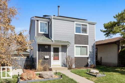 Two-story exterior featuring a gray siding facade with dark gray accent panels - 3736 12 Avenue, Edmonton, AB - Outdoor