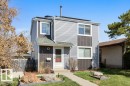 Two-story exterior featuring a gray siding facade with dark gray accent panels - 3736 12 Avenue, Edmonton, AB  - Outdoor 