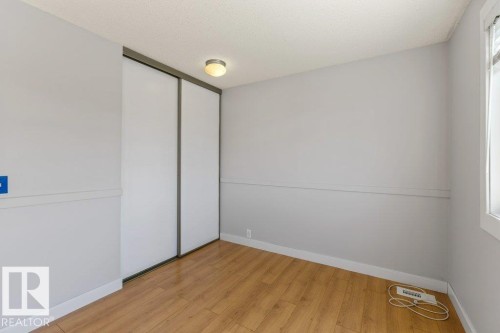 Room featuring wood-finish flooring, white baseboards, and light gray walls - 3736 12 Avenue, Edmonton, AB - Indoor Photo Showing Other Room