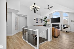 Vaulted ceilings with a contemporary chandelier and ceiling fan - 