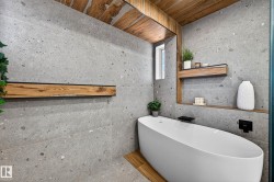 Freestanding oval soaking tub with matte black fixtures - 