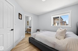 Light-filled room featuring wood-finish flooring and a window with white trim - 
