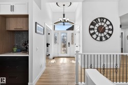 Foyer featuring a custom-designed front entry door with decorative glass panels - 