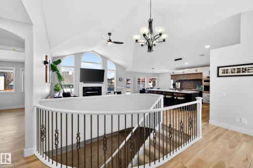 Curved staircase with wrought iron balusters and white handrail - 324 Cutts Crest, Edmonton, AB - Indoor Photo Showing Other Room