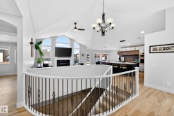 Curved staircase with wrought iron balusters and white handrail - 