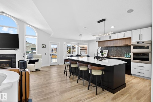 Open-concept living space with light wood-finish flooring - 324 Cutts Crest, Edmonton, AB - Indoor