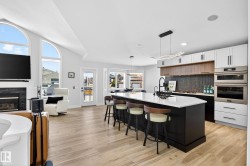 Open-concept living space with light wood-finish flooring - 