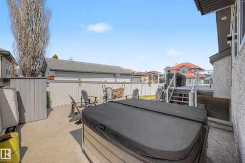 Outdoor hot tub with a dark cover on a concrete patio - 324 Cutts Crest, Edmonton, AB - Outdoor With Deck Patio Veranda