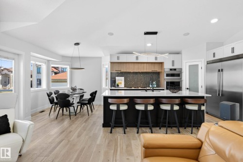 Open-concept living space featuring light wood-finish flooring throughout - 324 Cutts Crest, Edmonton, AB - Indoor
