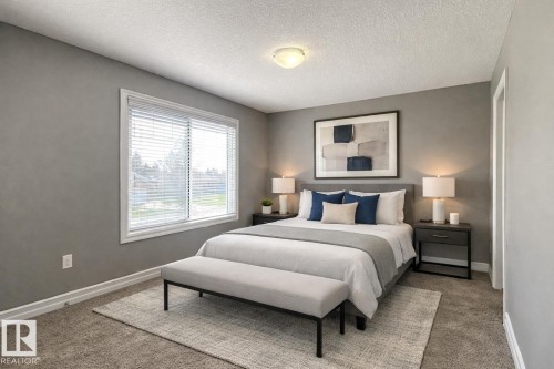 Spacious room featuring neutral gray walls, plush carpet flooring, a large window with white blinds, and a ceiling-mounted light fixture - 1520 105 Street, Edmonton, AB - Indoor Photo Showing Bedroom
