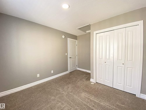 Neutral-toned wall paint and plush carpet flooring - 1520 105 Street, Edmonton, AB - Indoor Photo Showing Other Room