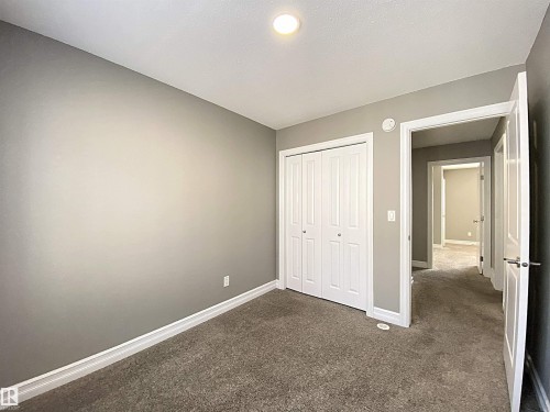Interior room featuring light gray walls, white trim, and gray carpeted flooring - 1520 105 Street, Edmonton, AB - Indoor Photo Showing Other Room