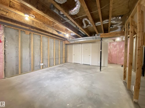 Unfinished basement offering expansive concrete flooring, exposed wood ceiling joists, and visible ductwork - 1520 105 Street, Edmonton, AB - Indoor Photo Showing Basement