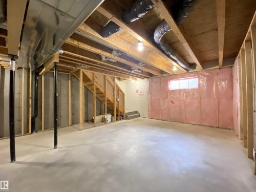 Unfinished basement featuring exposed wood joists and concrete flooring - 1520 105 Street, Edmonton, AB - Indoor Photo Showing Basement