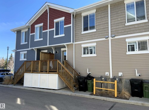 Multi-level exterior featuring varied siding materials including blue horizontal siding, red shake siding, and tan horizontal siding - 1520 105 Street, Edmonton, AB - Outdoor With Exterior